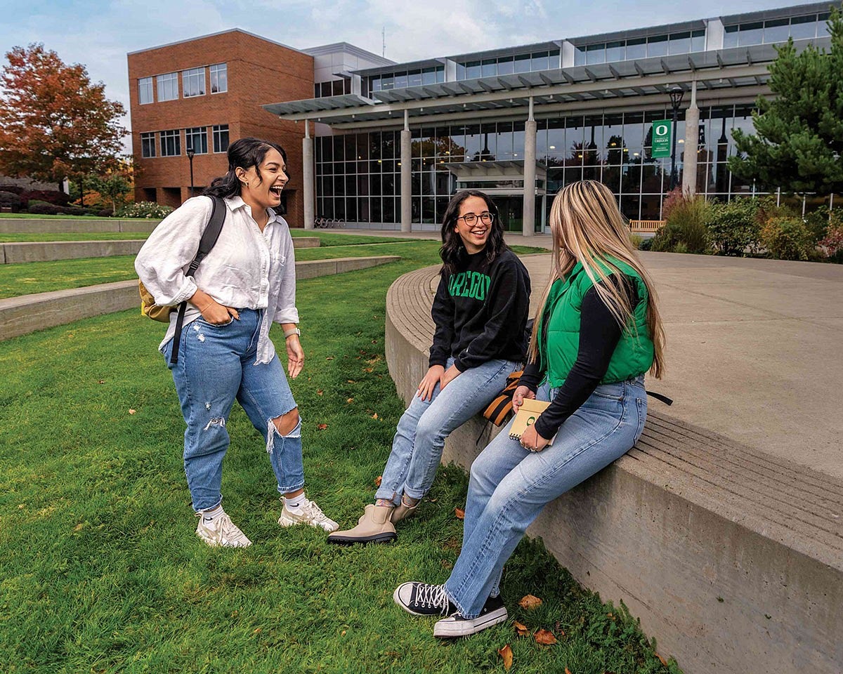 three students having a conversation on the UO Portland campus